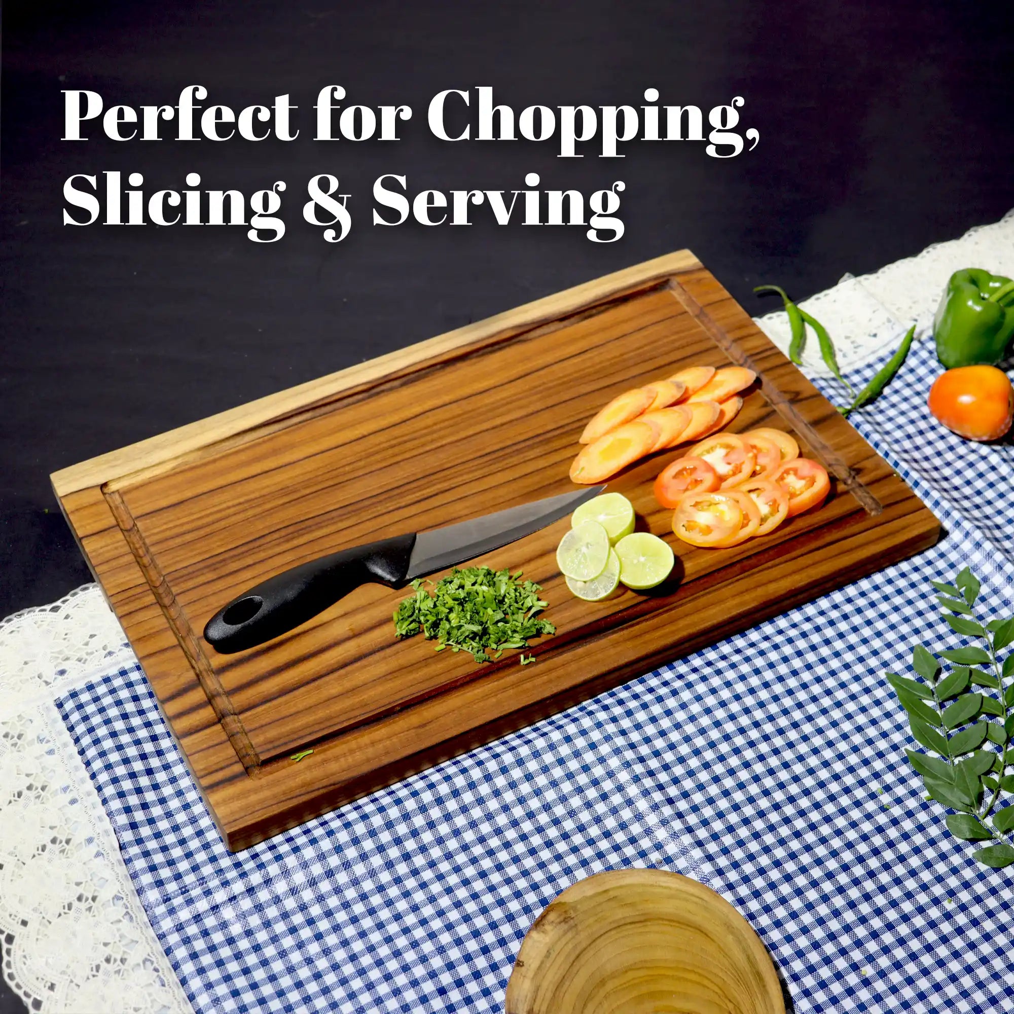 Wooden cutting board with knife and sliced vegetables on a checkered tablecloth