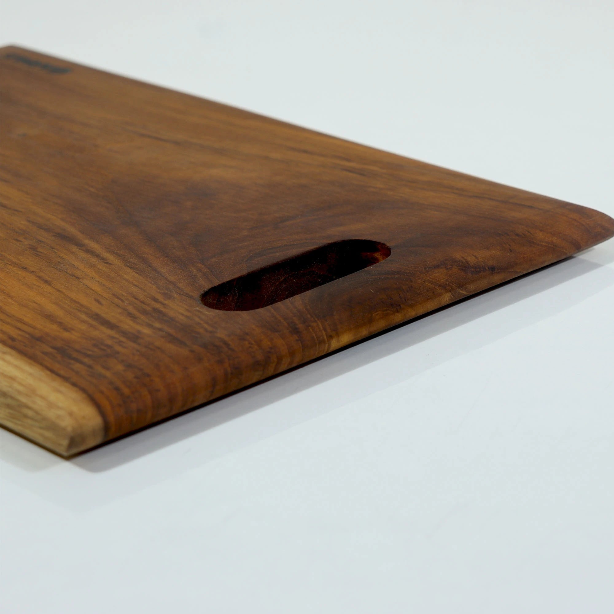 Organic Wooden chopping board with a handle on a white background