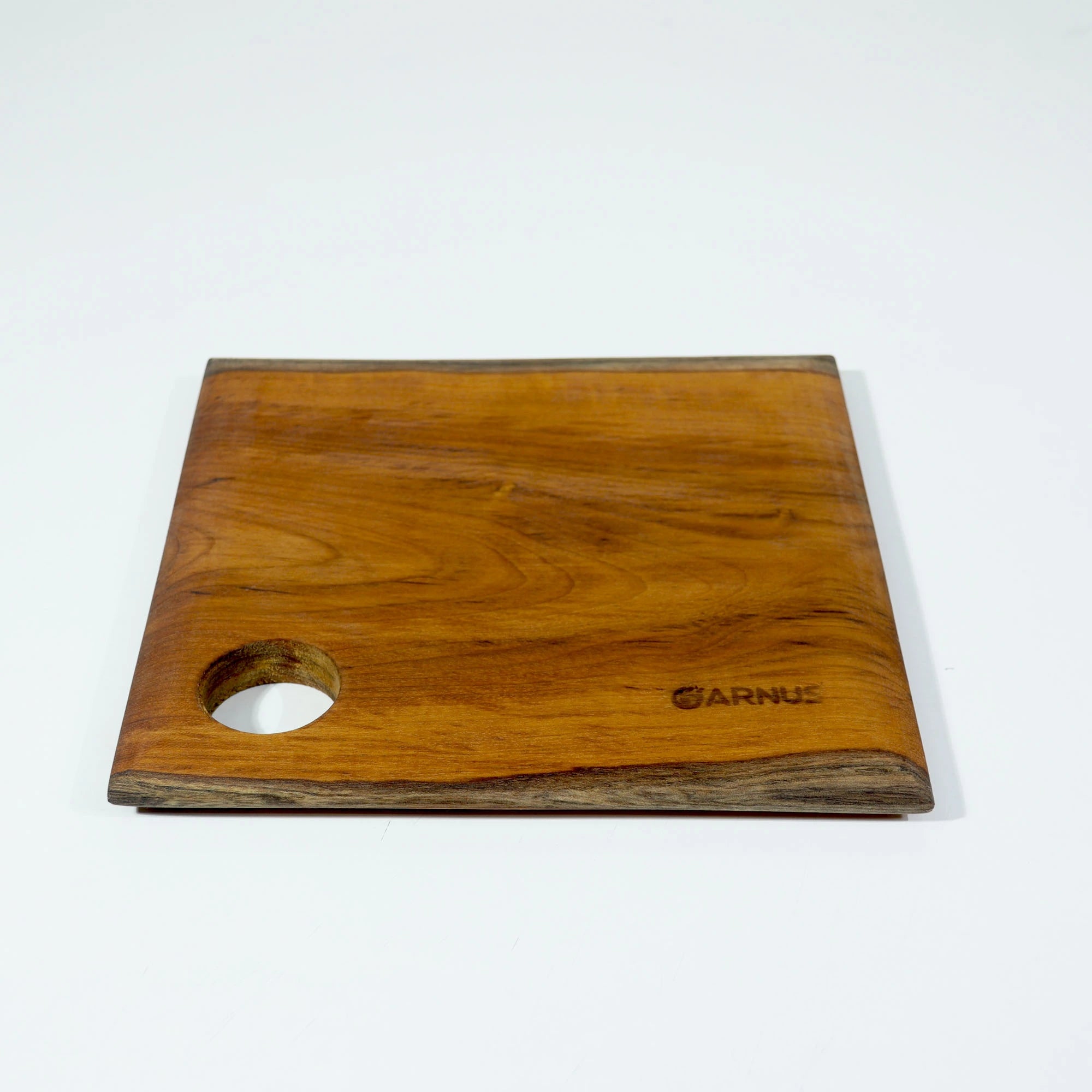 Wooden cutting board with a hole for a knife on a white background