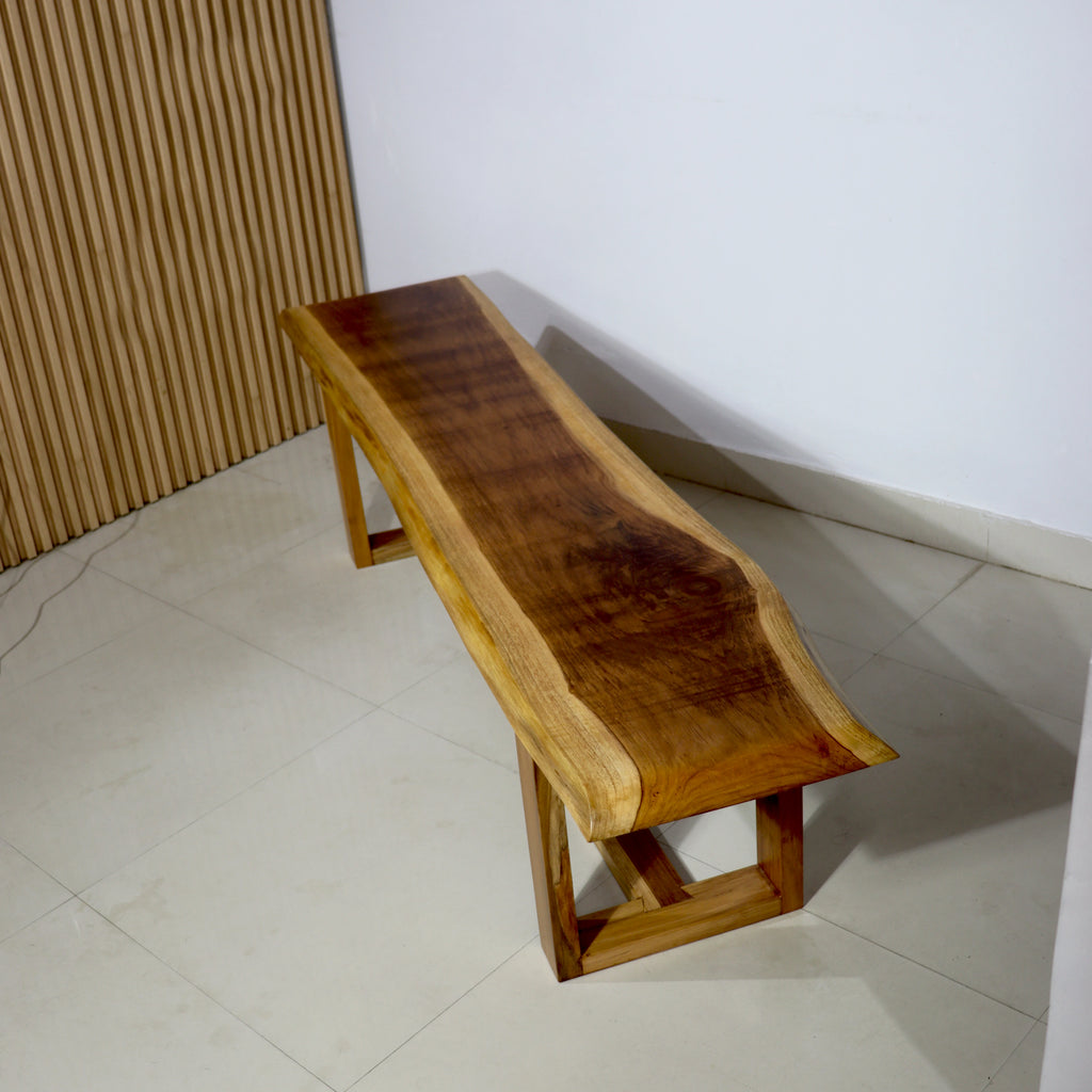 Wooden bench against a white wall with a textured brown panel