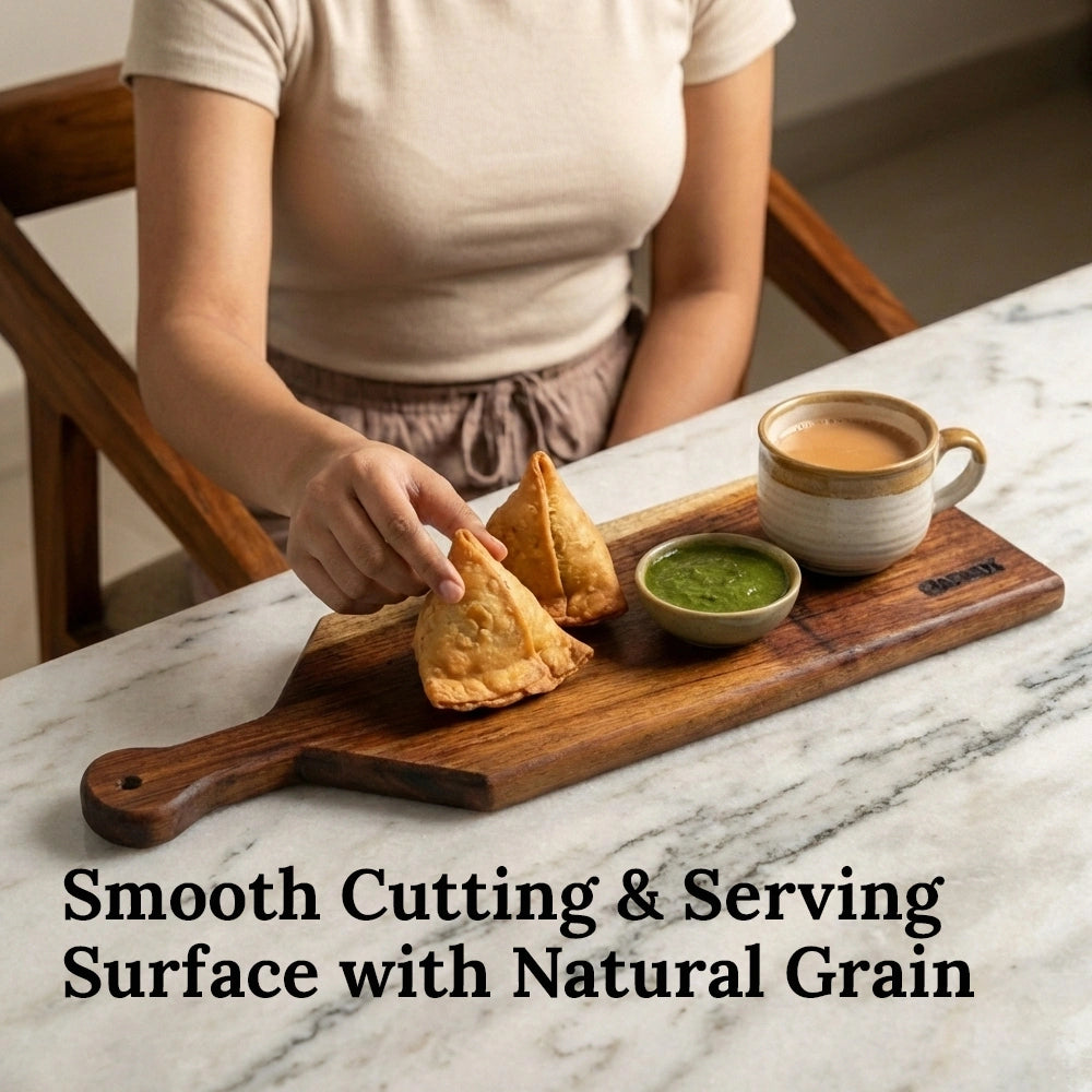 Person holding a samosa with a cup of tea and green chutney on a marble surface