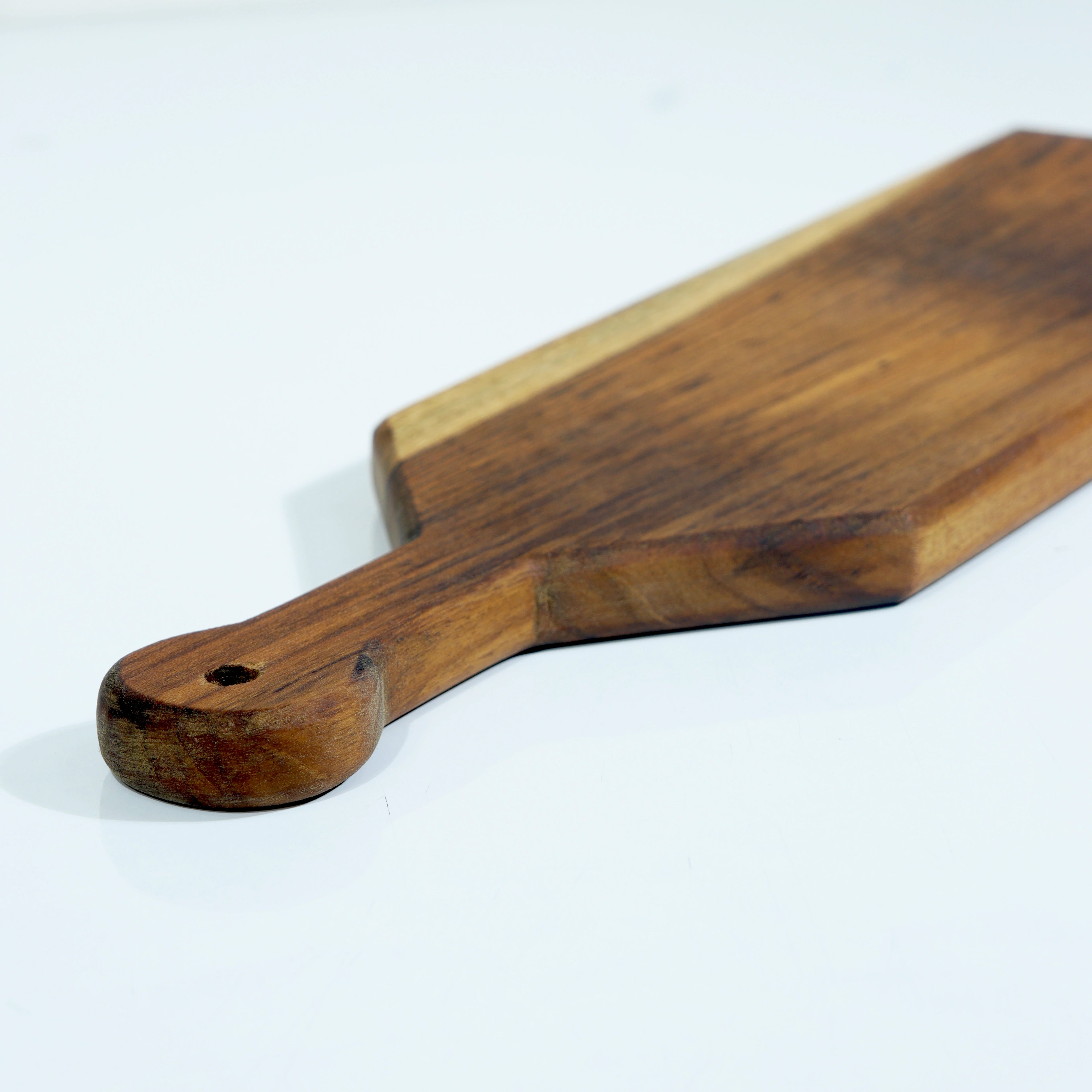 Wooden cheese board with handle on a white background