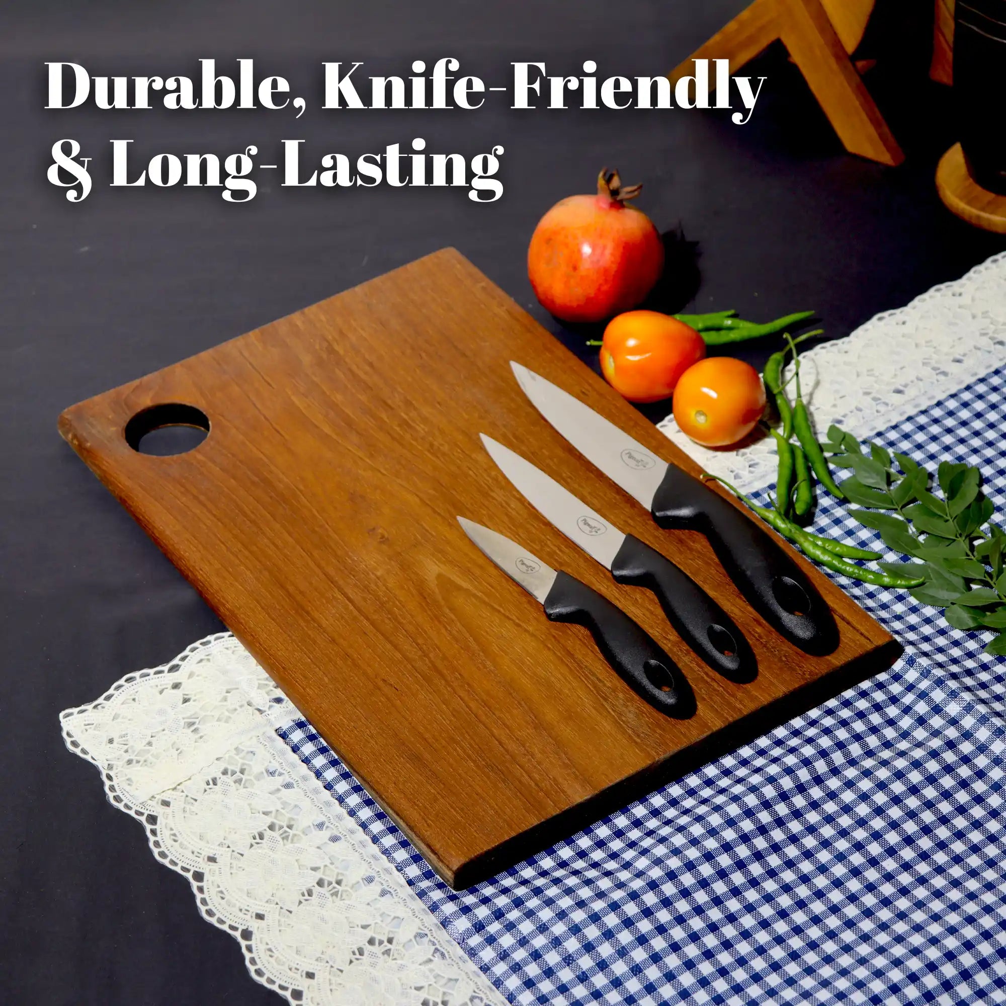 Wooden cutting board with knives and fruits on a checkered tablecloth