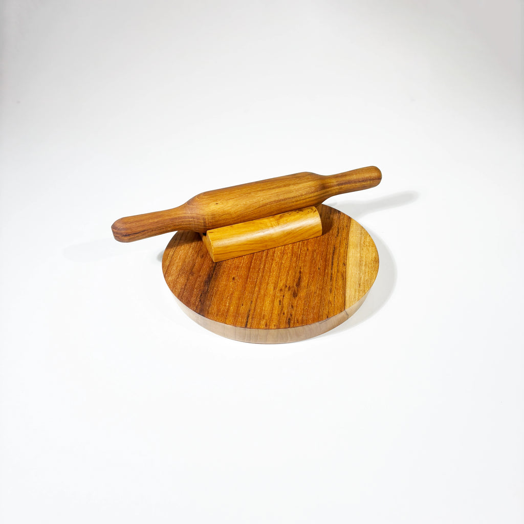 Wooden rolling pin and board on a white background